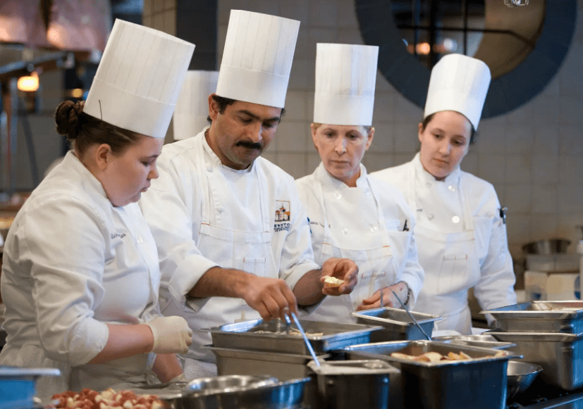 CIA students watch the chef prepare food at the garde manger station.