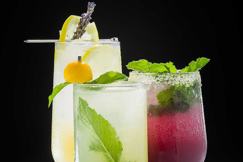 Try these Labor Day end of summer cocktail drink recipes by the CIA: Minted Mango Spritz, Lavender Lemonade, and Pomegranate Ginger Fizz.