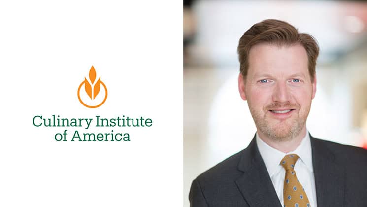 On the left, there's the Culinary Institute of America's logo and name. On the right, a man with brown hair, wearing a dark suit, white shirt, and yellow tie, smiles in a blurred indoor background.