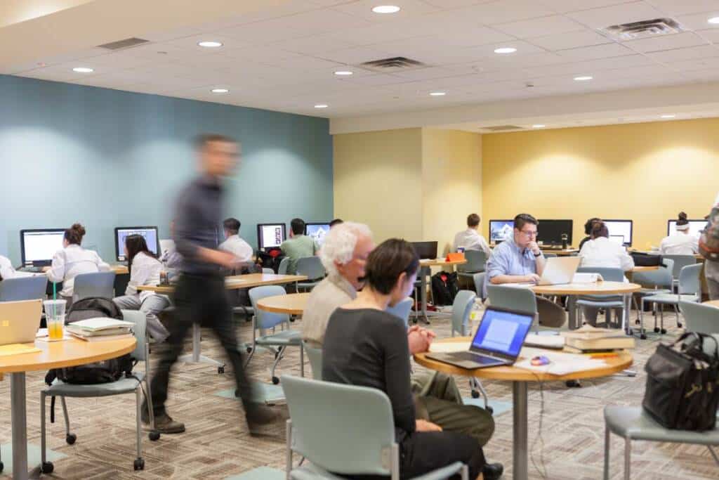 CIA students working at computers at tables in the CIA Learning Commons on the Hyde Park campus.