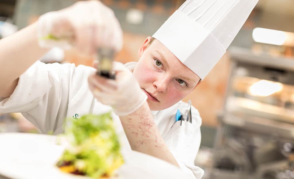 Real-World Experience - Student Plating Food