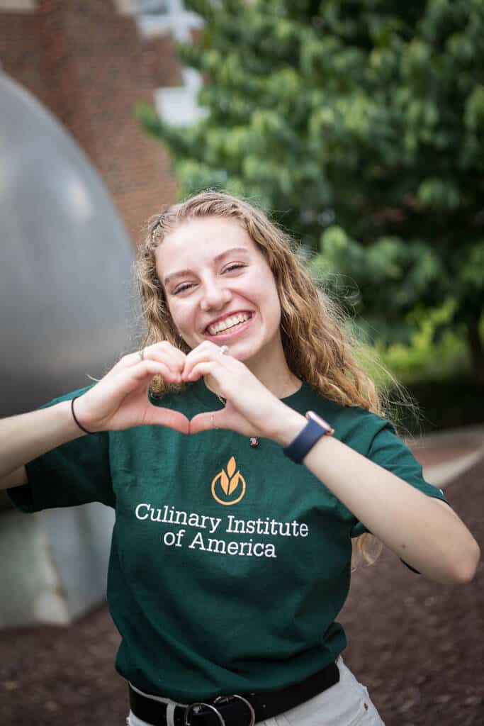 CIA student in new CIA attire near The Egg in the Student Commons on CIA’s New York campus.