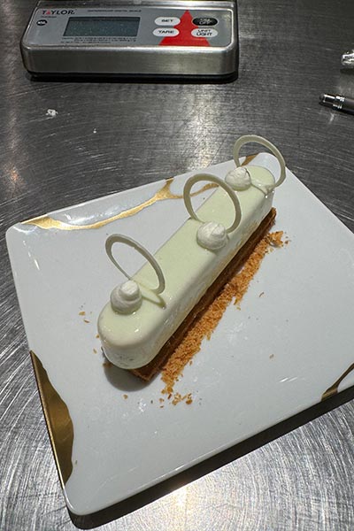 Image of a plated dessert on a table in a kitchen.