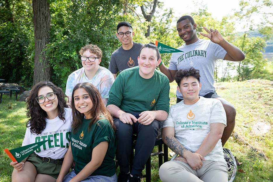 Image of CIA students in CIA swag sitting outside.