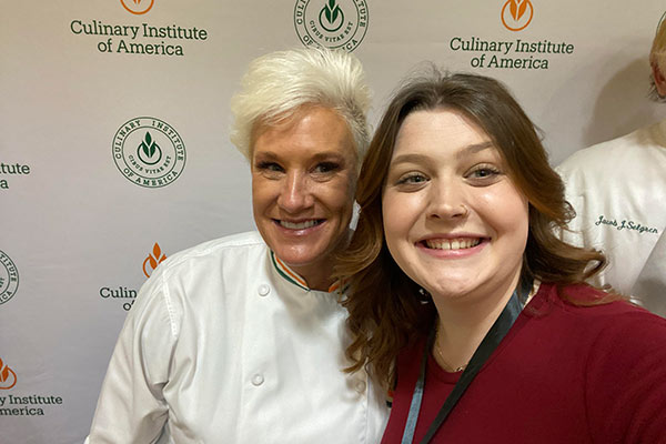 Image of CIA student Annie Milostan with CIA alumni celebrity chef,  Anne Burrell ’96.