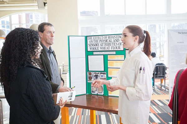 CIA Culinary Science student presenting her senior thesis in The Egg.