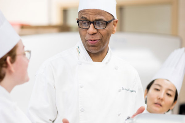 Richard J. Coppedge Jr., CIA faculty in New York—Professor, Baking and Pastry Arts, with students.