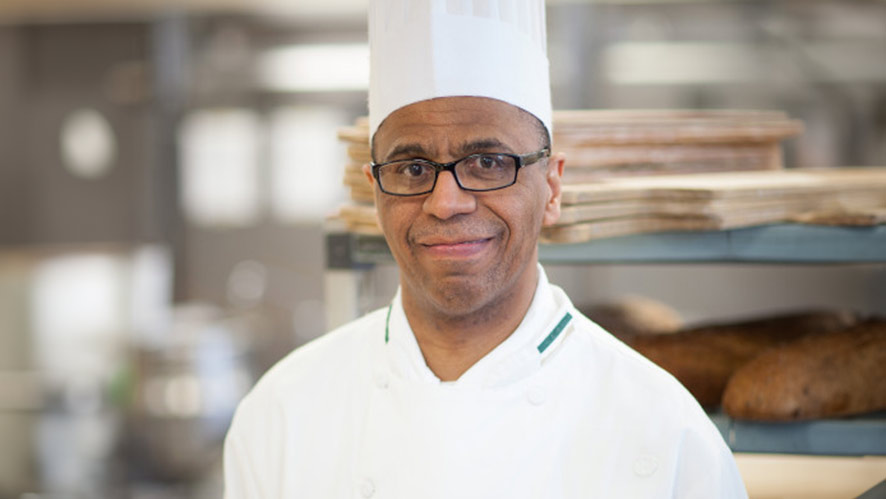 Image of Chef Richard Coppedge Jr. smiling in a CIA bakeshop.