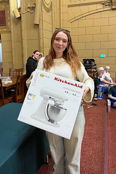 Image of a CIA student winning a KitchenAid Stand Mixer at the Late-Night Breakfast at CIA.