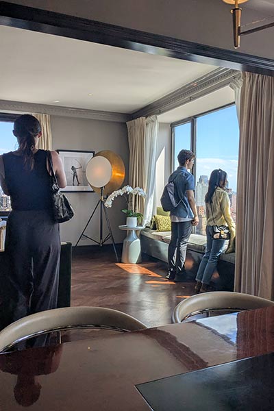 Image of CIA students checking out the view of New York City from a hotel room in the Carlyle Hotel.