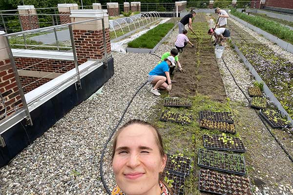 Image of CIA instructor Isabella Missel with her students in a CIA student roof garden.