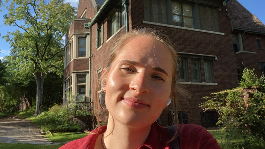 Image of Isabella Missel standing in front of a house.