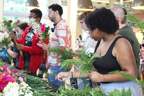 Image of CIA students looking at flowers during Pollinator Week.