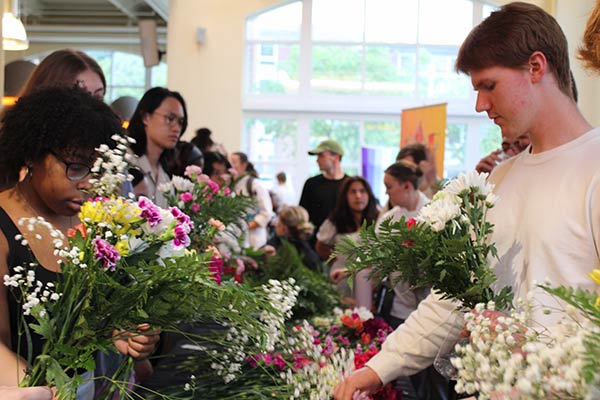 Image of CIA students looking at flowers during Pollinator Week.