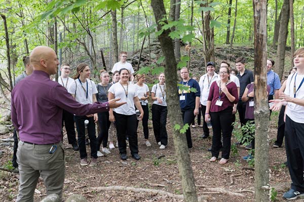 Image of students visiting CIA’s shiitake mushroom log site with CIA Professor Dr. Taylor Reid.