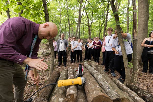 Image of students visiting CIA’s shiitake mushroom log site with CIA Professor Dr. Taylor Reid.
