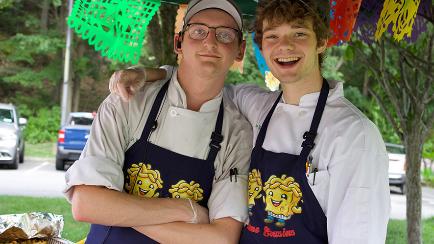 Image of two CIA students competing in the second annual Mac and Cheese Cook-Off held at CIA New York.