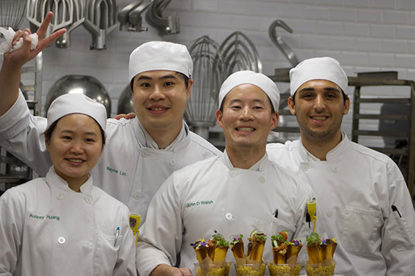 Image of four CIA students competing in the second annual Mac and Cheese Cook-Off held at CIA New York.