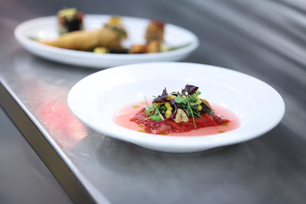 Image of a plated dish on the counter waiting for service.