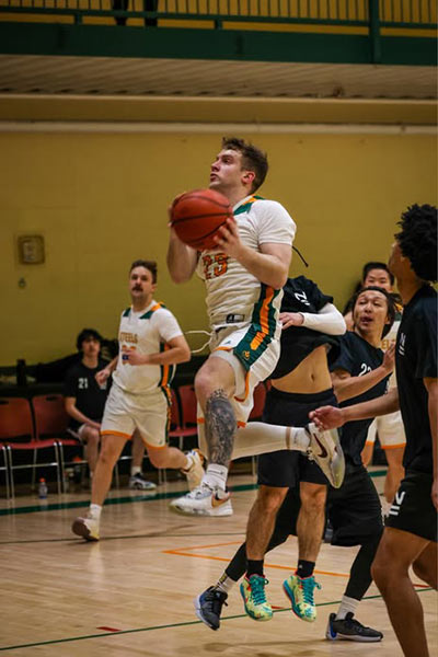 Image of a CIA basketball member going up for a layout in a game at CIA campus in Hyde Park, NY.