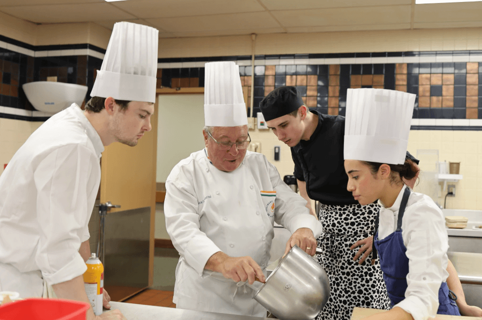 CIA students from Inn at Little Washington, French Laundry, and SingleThread watch an instructor demonstrate in class.
