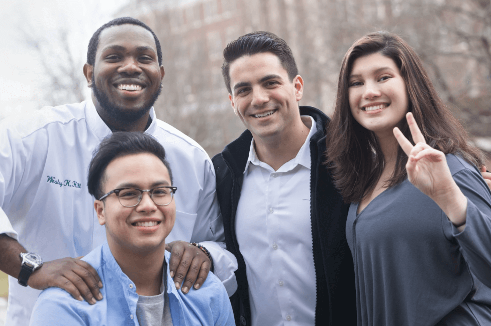Students at The Culinary Institute of America's New York campus smile for the camera.