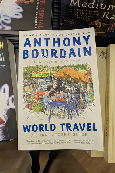 Image of Anthony Bourdain’s book, World Travel in CIA’s bookstore.