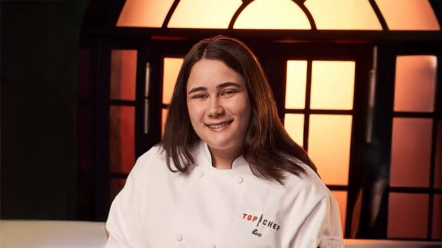 Image of CIA student Eva Kopelman in a white "Top Chef" coat.