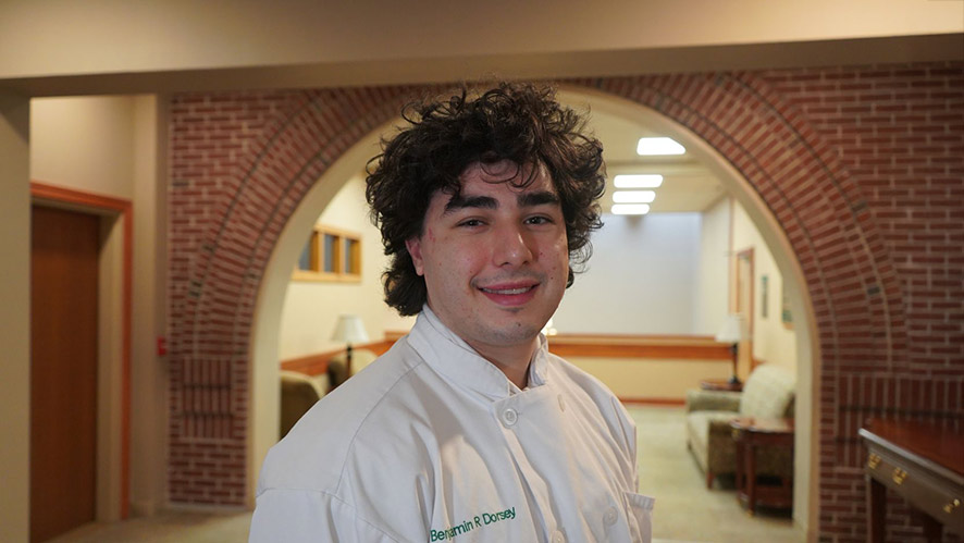 Culinary student Ben Dorsey at CIA’s Hyde Park campus, highlighting hands-on culinary training experience.