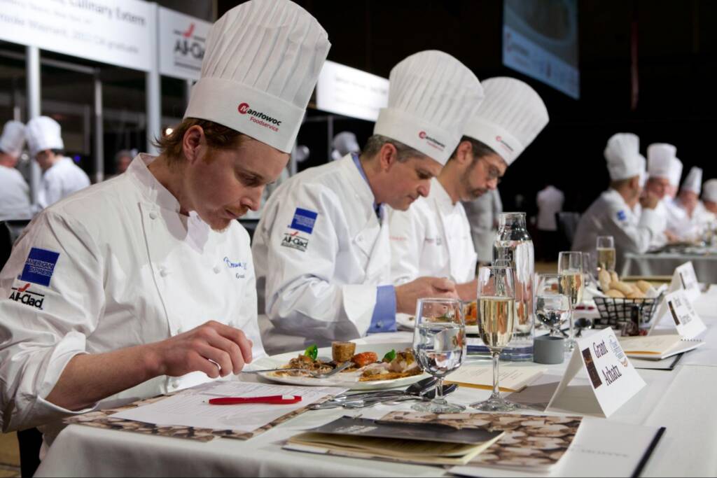 CIA alumni and Michelin star chef Grant Achatz evaluates a dish at the Bocuse d'Or competition.