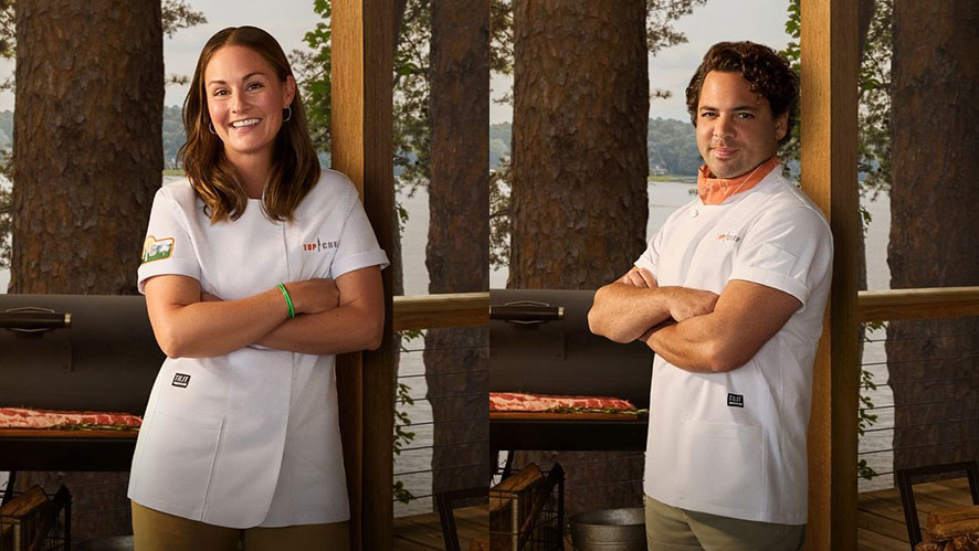 Jennifer Lee Jackson and Justin Tootla standing outside side by side, smiling in white Top Chef aprons.